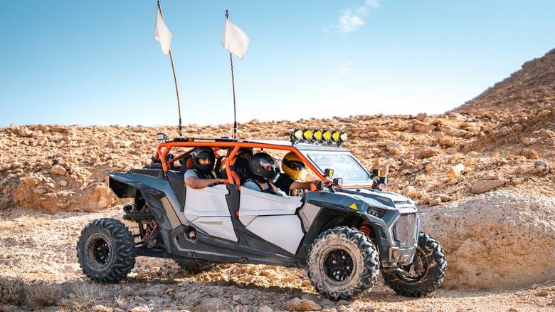 An off-road UTV parked on a rocky landscape.