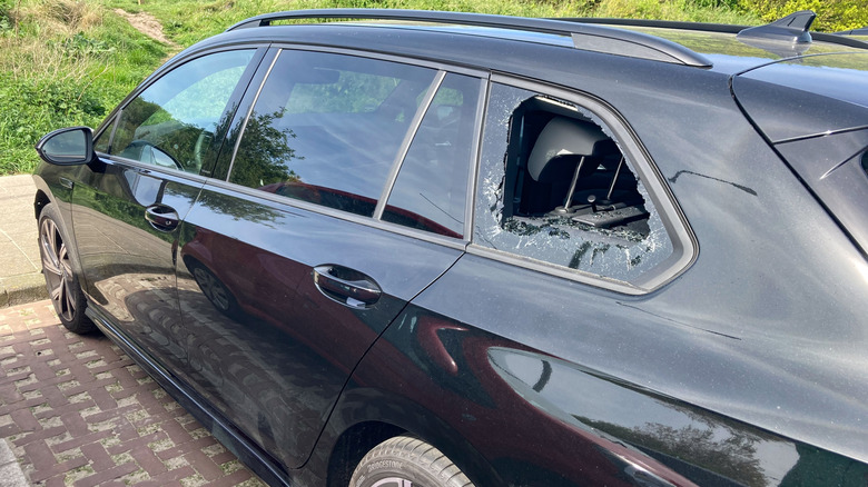 A broken car window on a car after a theft attempt
