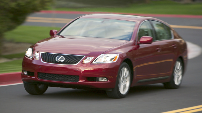 Red 2006 Lexus GS 300 driving on road, front 3/4 view