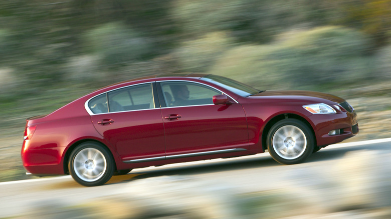 Side view of a red 2006 Lexus GS 300 driving on a road