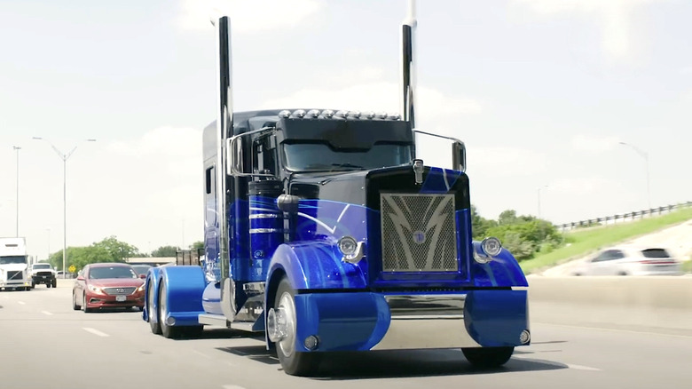 Person driving Kenworth semi truck on freeway
