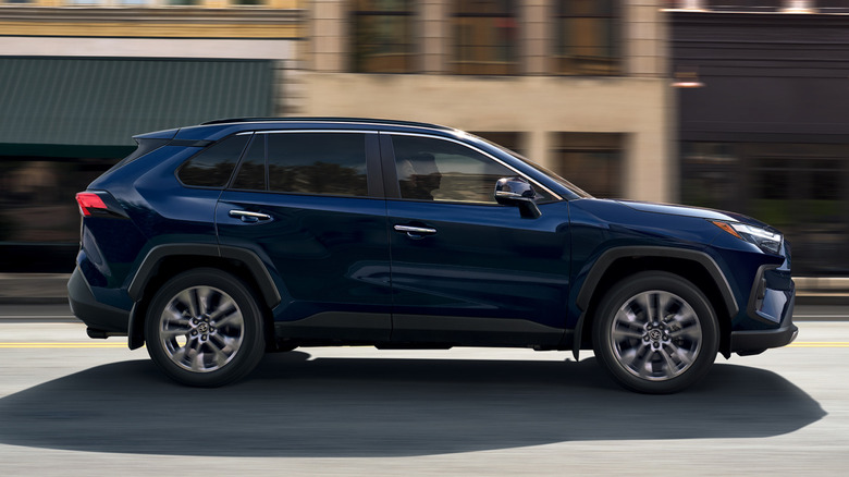 Side view of a 2025 Toyota RAV4 driving down the street