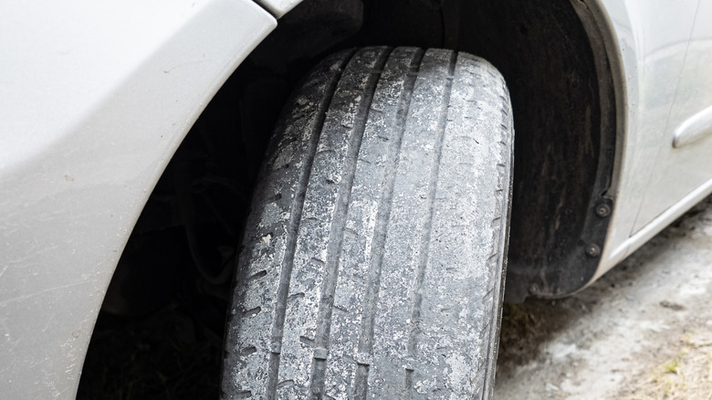Close-up of heavily worn tire on passenger car