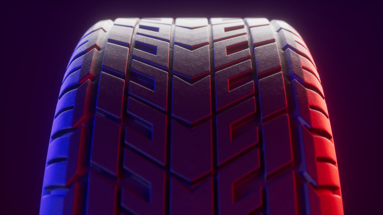 Close-up of tire tread with red, white, and blue lighting