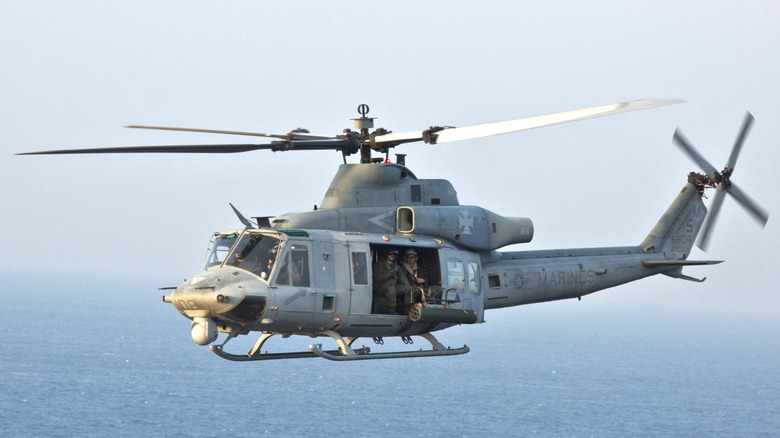 A UH-1Y Venom flying low over the ocean