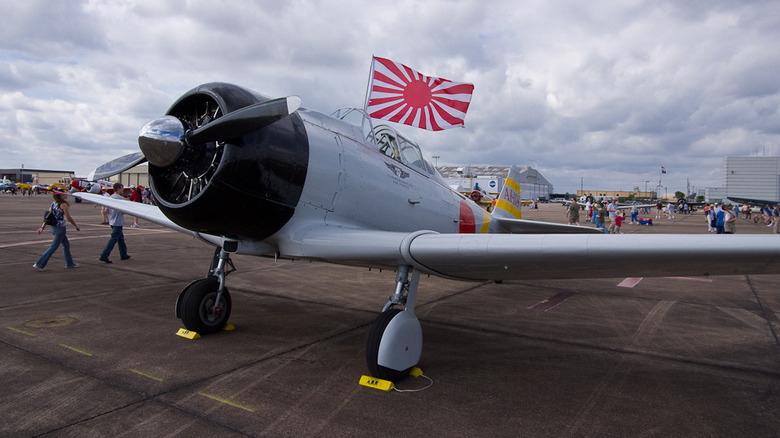 A parked Japanese fighter plane displaying the rising sun flag