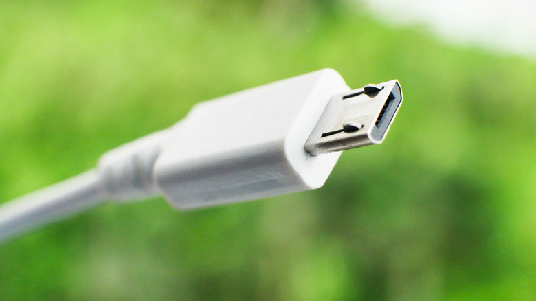 white micro-usb cable with grass in the background