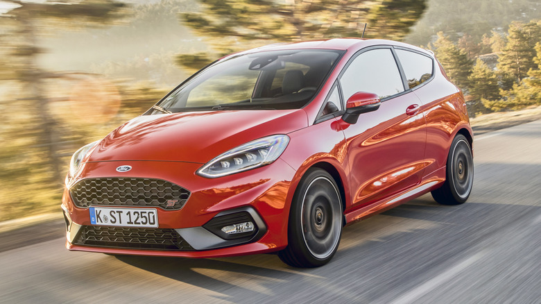 A Ford Fiesta ST driving through a mountain pass
