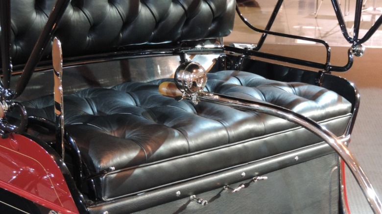 The driver's seat of a 1903 Oldsmobile Curved Dash up close
