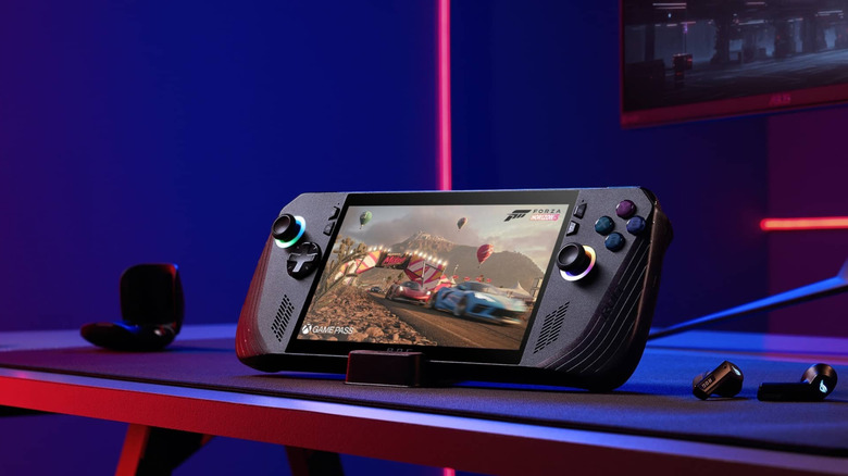 Asus ROG Ally X on a desk next to computer monitor