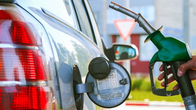 Person refueling their vehicle with diesel fuel at a gas station