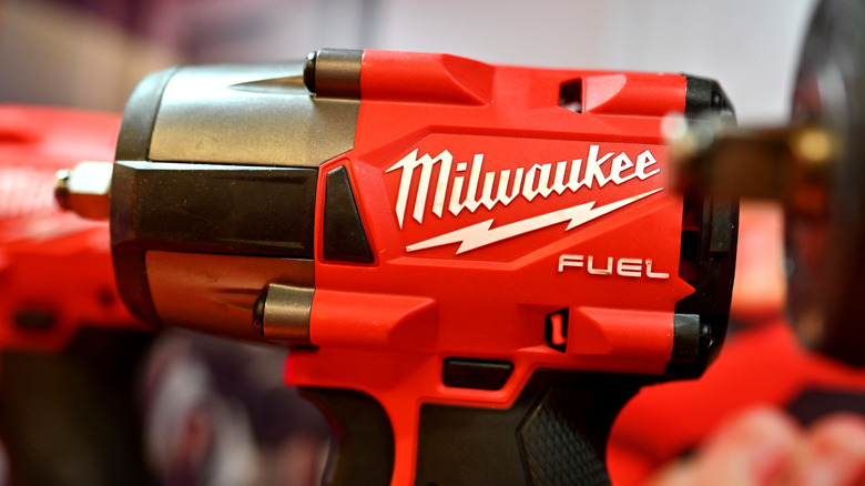 Milwaukee tools on display at a trade show, impact wrench in focus