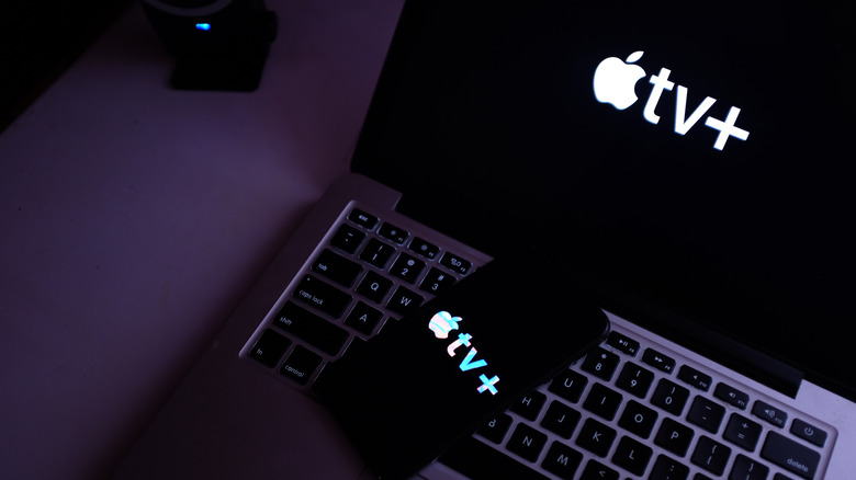 Apple TV+ logo on iPhone and MacBook