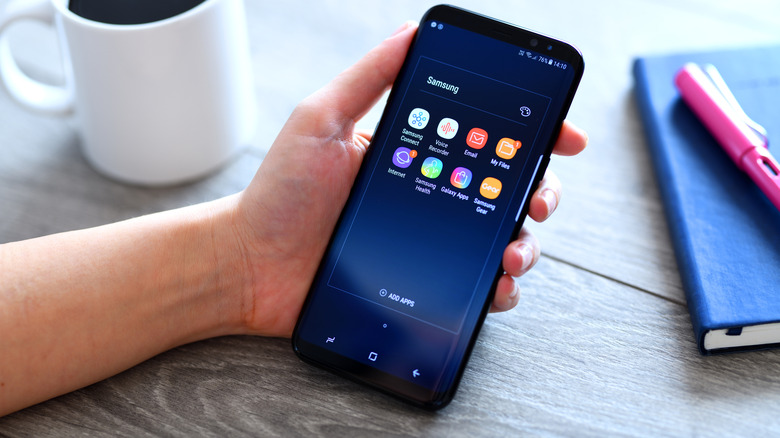A person holds the Samsung Galaxy S9 Plus