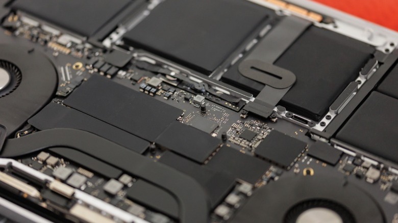 Closeup of laptop internals showing chips and heatpipes