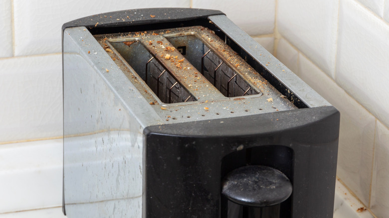 Crumbs and grime building up on a toaster.