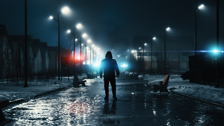 Hooded man in dark alley