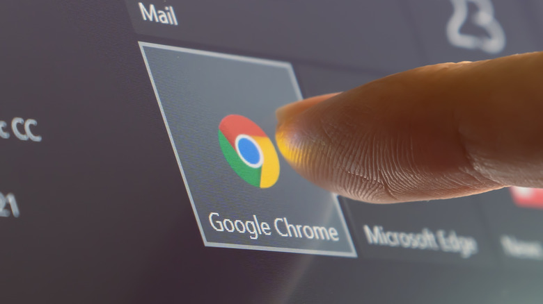 Finger tapping Google Chrome icon