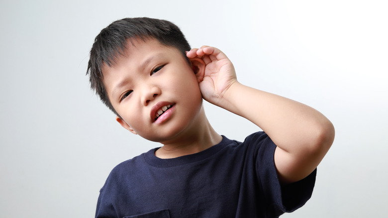 little boy trying to hear