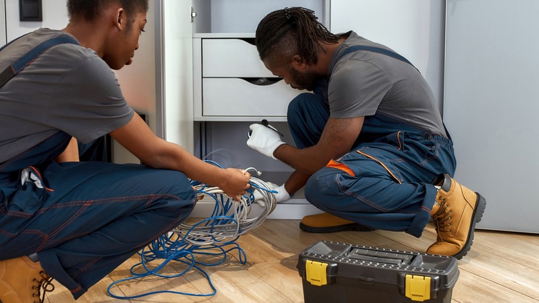 People installing network equipment