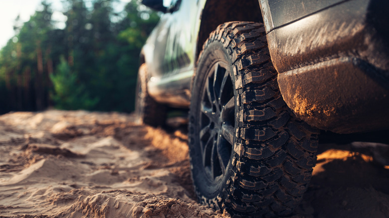 SUV off-roading with specialized off-road tire designed for high rolling resistance