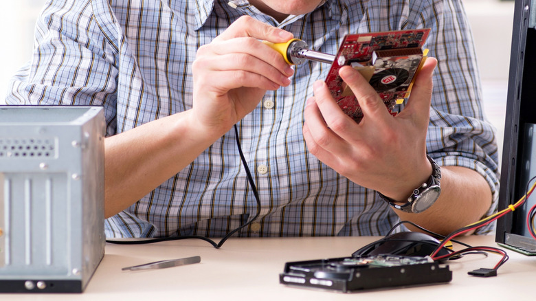 Repair technician fixing a computer