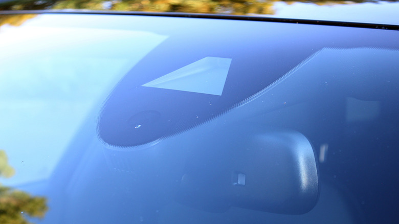 A car equipped with cameras in the windshield and rearview mirror