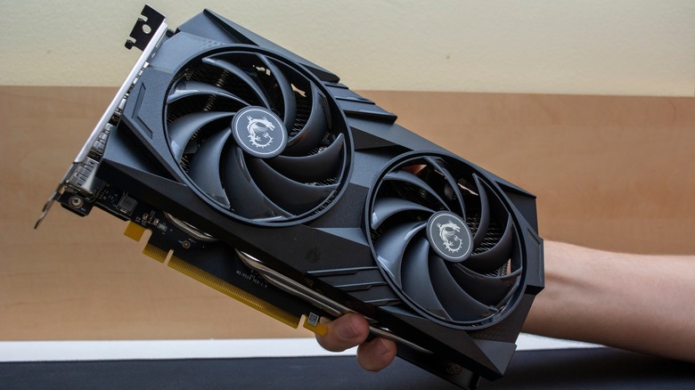 A person holds the Nvidia RTX 4060 Ti graphics card