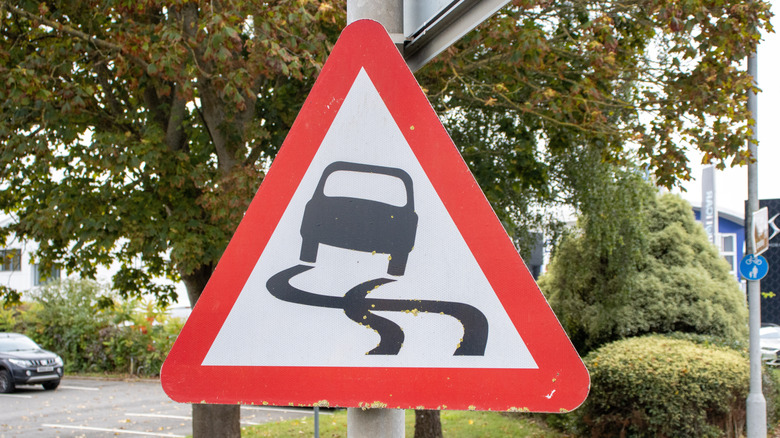 Sign displaying car skidding out on road