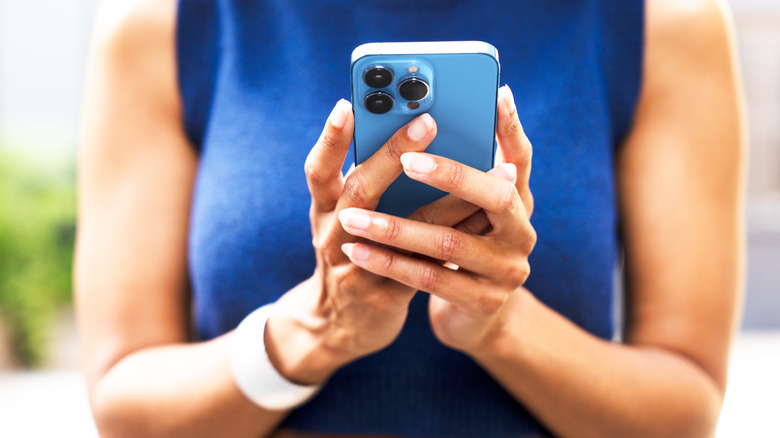 A woman using a Pro iPhone model.