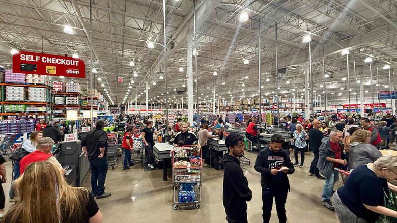 People shopping at a Costco, which requires a membership
