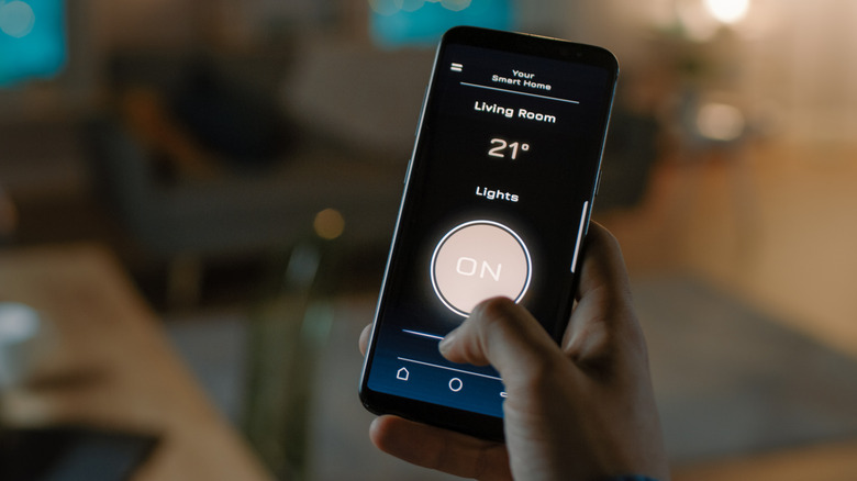 Close up of a person controlling their smart bulb using the app connected to Wi-Fi
