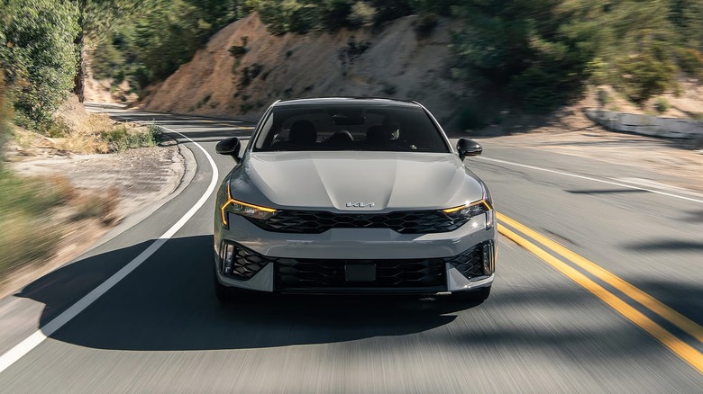 A gray 2026 Kia K5 GT on mountain road
