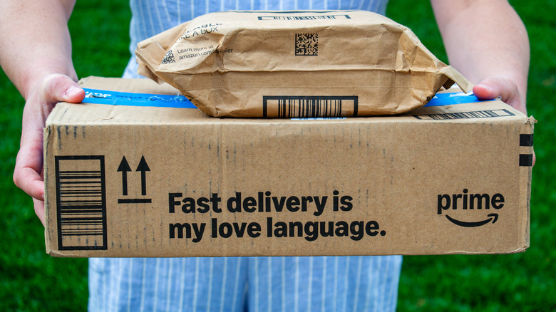 A woman holds Amazon Prime packages