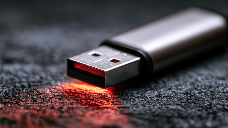 A close up shot of a usb flash drive, emitting a soft red glow
