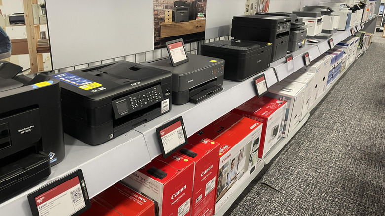 Best Buy retail store with printers lined up on a shelf