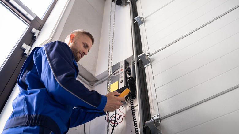 Man repairing a garage door opener
