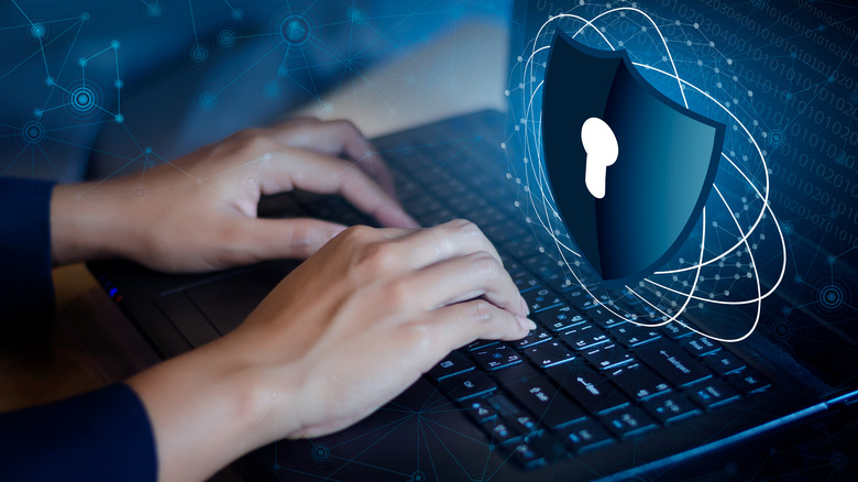Typing on protected laptop.