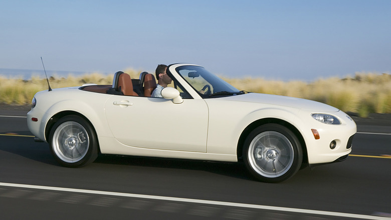 White 2007 Mazda MX-5 Miata driving.