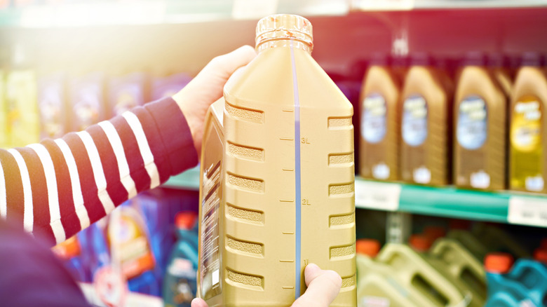 Man checking oil at a shop