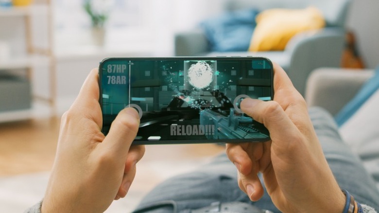person playing game on smartphone