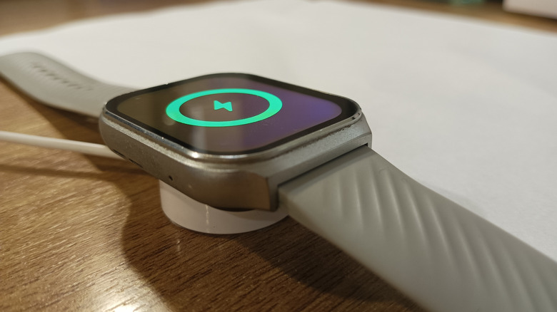 Apple Watch showing green charging logo while on wireless charger