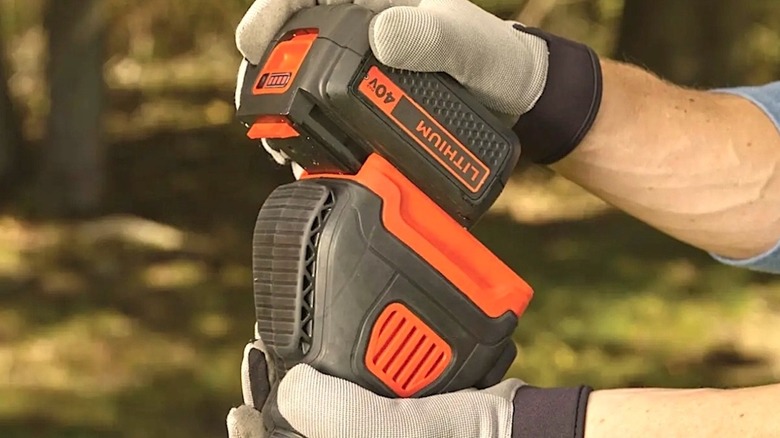 Person using Black and Decker battery