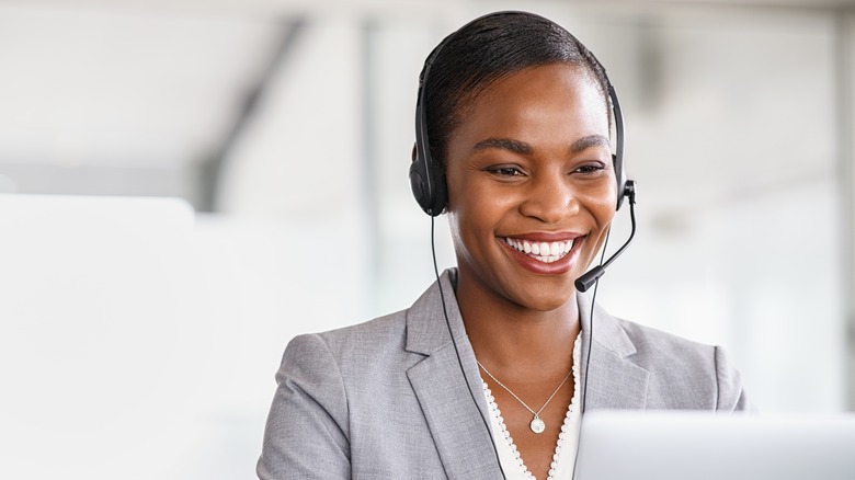person wearing headset with microphone sitting in front of computer