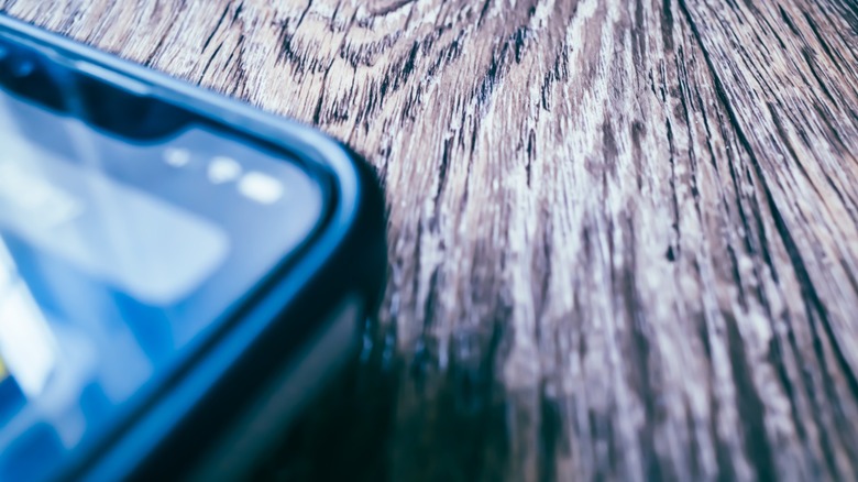 Close up of iphone on wooden table