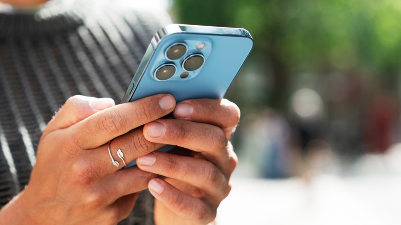 Close up of a person holding an iPhone