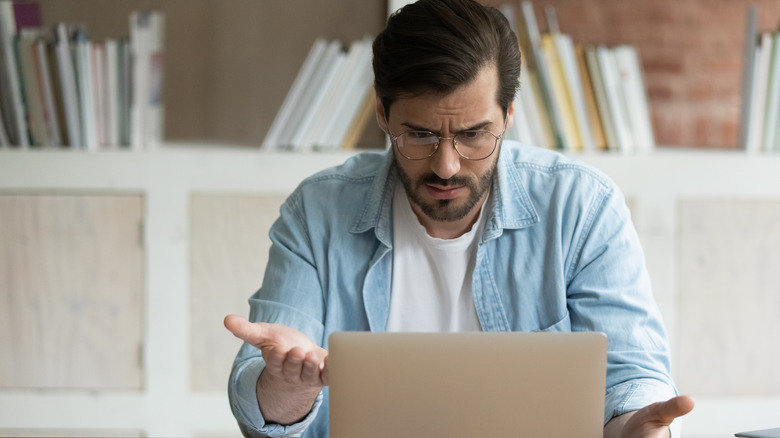 Person frustrated at a laptop