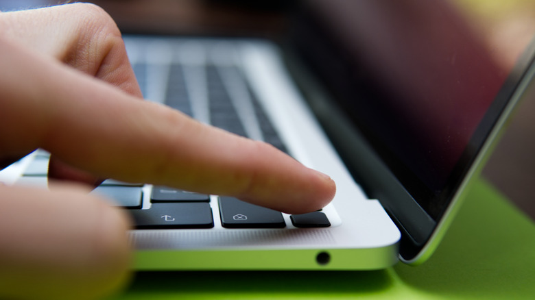 MacBook power button being pressed