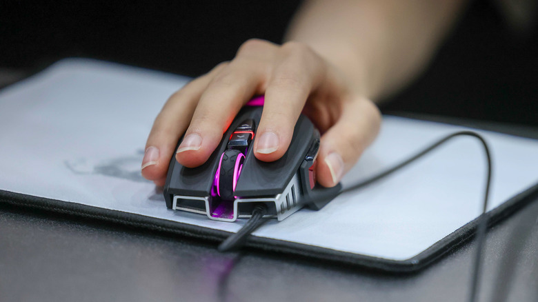 black gaming mouse with RGB lights on a mousepad