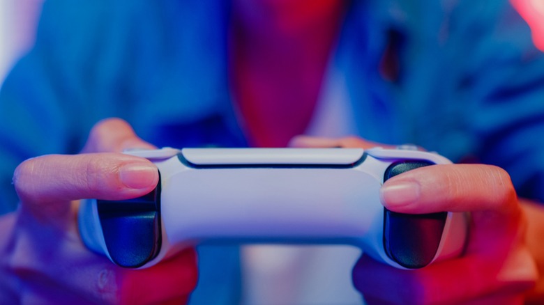 Person holding DualSense controller